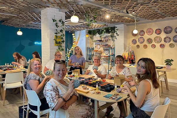 Workshop participants crafting mosaic lamps